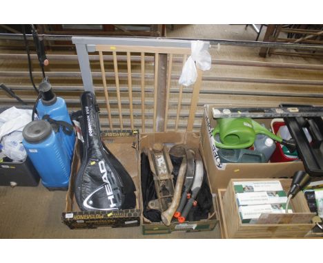 A box containing a small axe, two saws, trolley jack etc.