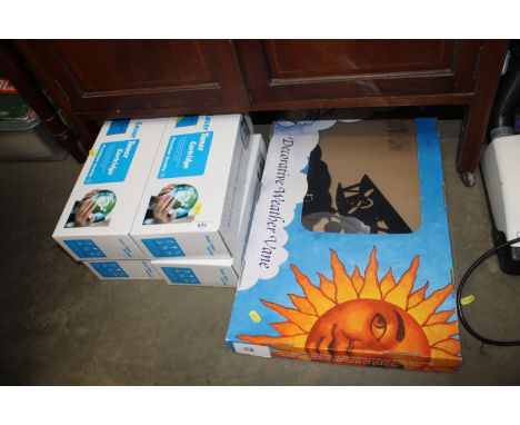 A decorative weather vane and a quantity of toner cartridges