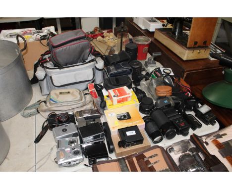 A quantity of various cameras to include Kodak, Canon, Minolta etc. together with various accessories and bags. Sold as seen