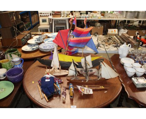 A collection of various model boats, wooden figures and a puppet