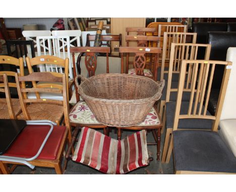 A set of four reproduction mahogany dining chairs, a reproduction mahogany carver chair, an oak framed chair, a wicker basket