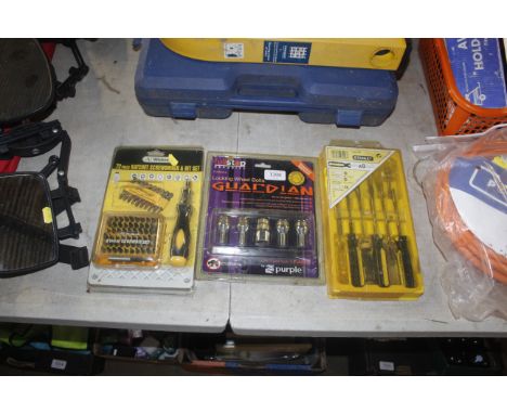 A set of Stanley screwdrivers, a 72 piece ratchet screwdriver and set of locking wheel bolts  