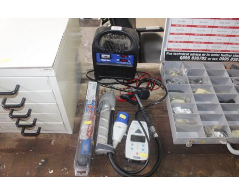 A battery charger, Q tech digital RCD tester, tyre inflator and a 0.375 torque wrench