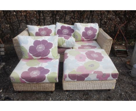 A rattan garden set comprising settee, chair and table base