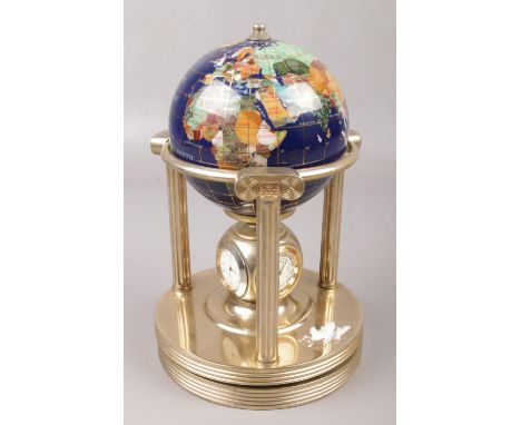 A hardstone set world globe, raised on brass ionic pillars with clock hygrometer and thermometer to the rotating base.  