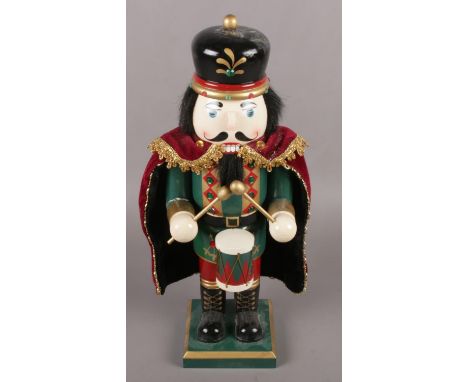 A painted wooden novelty nut cracker formed as a soldier.  
