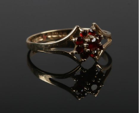 A 9ct gold garnet cluster ring, Size P. (1.47g).  