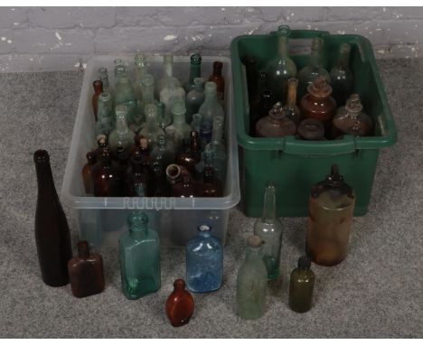 Two boxes of vintage glass bottles to include advertising and coloured examples etc.  