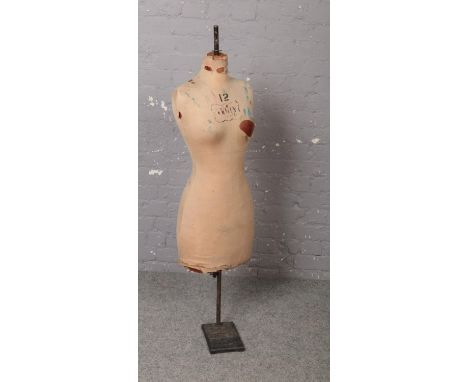 A vintage Yugin &amp; Sons tailors dummy or mannequin. Female in form, stencilled number 12 and with Yugin bow logo, raised o