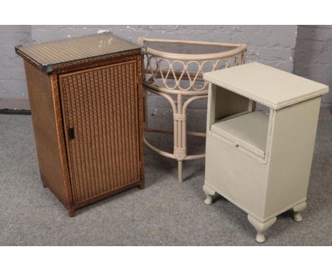 A Lloyd loom bedside cabinet along with another Lloyd loom cabinet and a glass top side table.  