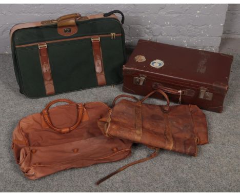 A vintage leather suitcase with leather mounts, stencilled R.E.S along with a quantity of holdall bags.  