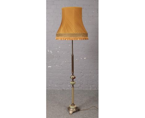 A reeded brass and onyx standard lamp with mustard shade.  