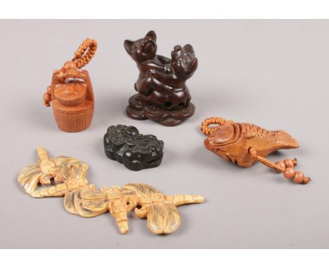 A box of oriental collectables including carved netsuke.  