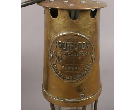 The Protector Lamp &amp; Lighting Co Miners lamp, to include two other similar examples  