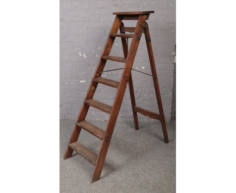 A wooden vintage step ladder.  
