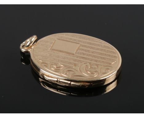 A vintage 9ct gold locket with engine turned decoration, assayed Birmingham 1984. (3.34g).  