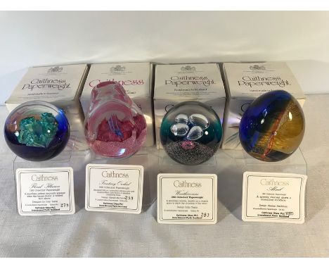 Caithness glass paperweights x 4 with stands.