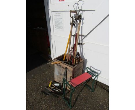 Garden tools including fork and scythe in vintage tea chest 