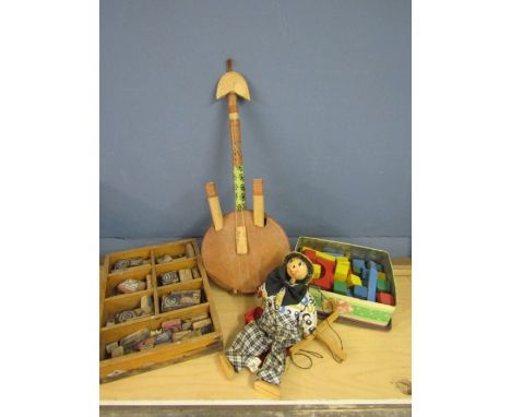 Vintage stamp blocks, building blocks, a banjo and a puppet