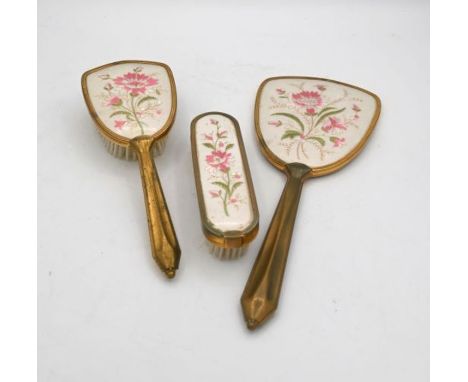 three piece mounted dressing table set, comprising hand mirror, hair brush and clothes brush, each with engine turned decorat