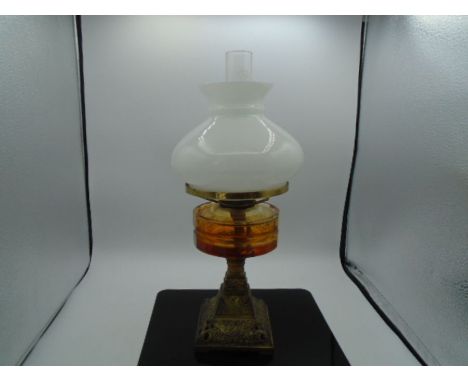 An 'Amber' glass oil lamp - marked 'Griffin brand' on chimney 