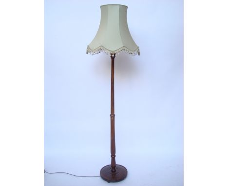 A walnut standard lamp. 
