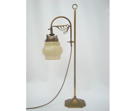 An Edwardian brass desk lamp, with later 1930's glass shade.
74cm high. 