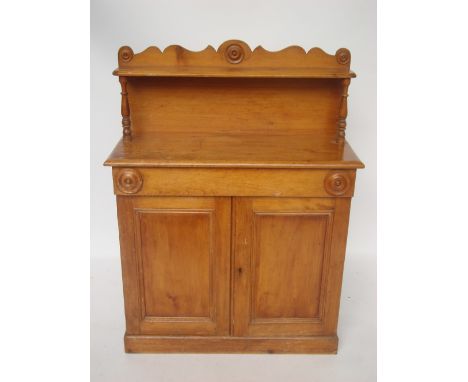 A Victorian pine chiffonier, the upper section with wavy edge gallery and single shelf on turned supports, the lower section 