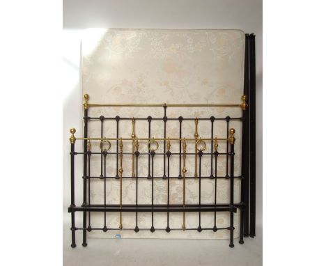 A Victorian style black painted cast iron and brass double bed frame with irons. 