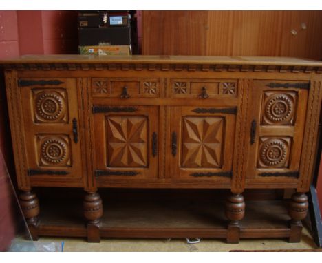 A late 19th/early 20th Century Northern French large light oak buffet, with a pair of central short drawers and a pair of pan