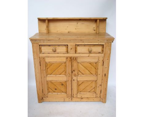 A Victorian pine chiffonier, the two plank top with raised shelf on turned supports above two short drawers and a pair of pan