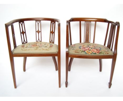 Two similar Edwardian mahogany tub armchairs, with strung frames, open slated backs and padded tapestry seats, each bearing p