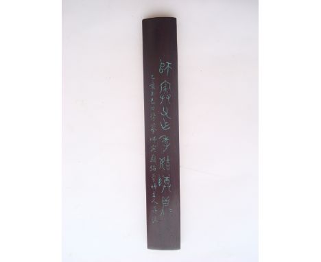 A Chinese hardwood scroll weight decorated with calligraphy.  