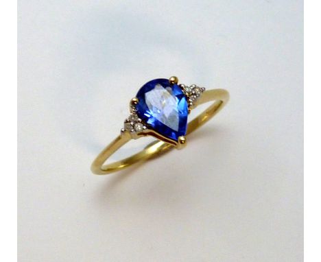 A TANZANITE AND DIAMOND RING, the pear shape tanzanite with single cut diamond sides to the plain band, stamped 10K, ring siz