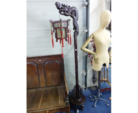 A CHINESE CARVED HARDWOOD STANDARD LAMP, the hexagonal hanging lantern inset with glass panels decorated with flowers and bir