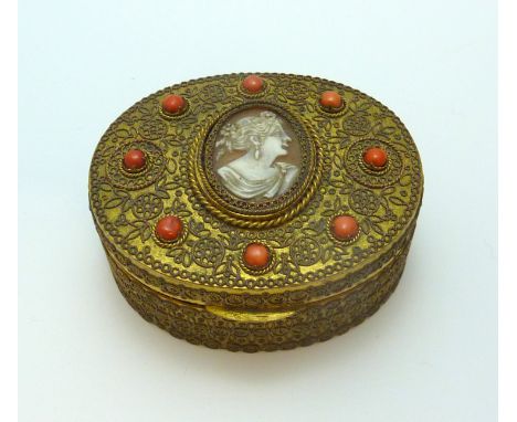 A TRINKET BOX, of oval shape with central cameo with woman in profile with coral accents