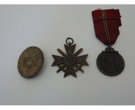 A GROUP OF THREE MEDALS TO THE GERMAN ARMY (WEHRMACHT) FOR WWII, 3rd Reich, 2nd Class War Merit Cross, no ribbon, together wi