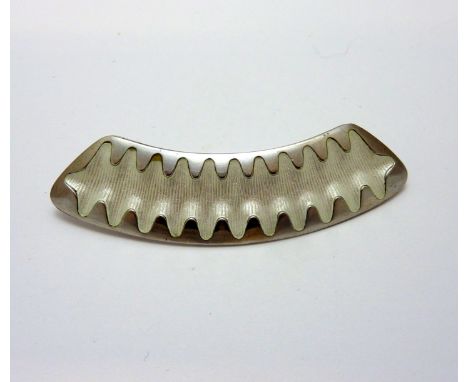 A BROOCH, with white enamel detail, stamped 925s Alch