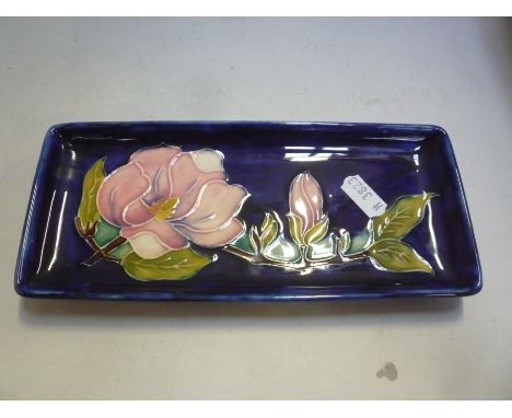 A MOORCROFT POTTERY RECTANGULAR TRINKET DISH, 'Magnolia' pattern design, length 20.5cm