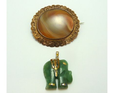 TWO ITEMS OF JEWELLERY, an antique agate brooch with decorative border and a jade and gold elephant pendant