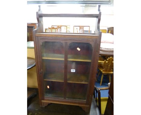 A SMALL EDWARDIAN WALNUT GLAZED CABINET, with shelf above (key)