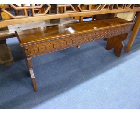 A CARVED OAK BENCH