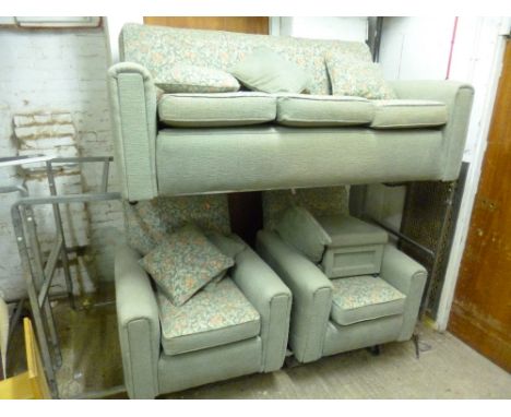 AN UPHOLSTERED THREE PIECE SUITE, comprising of a three seater settee, a pair of armchairs and a pouffe (4)