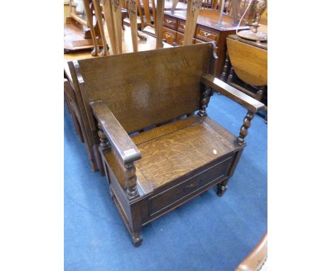 A SMALL OAK MONKS BENCH, with barley twist supports