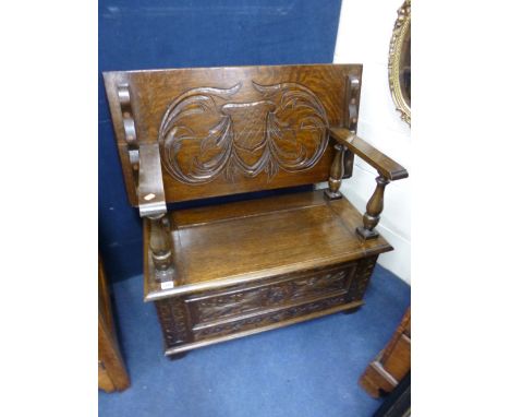 A CARVED OAK MONKS BENCH