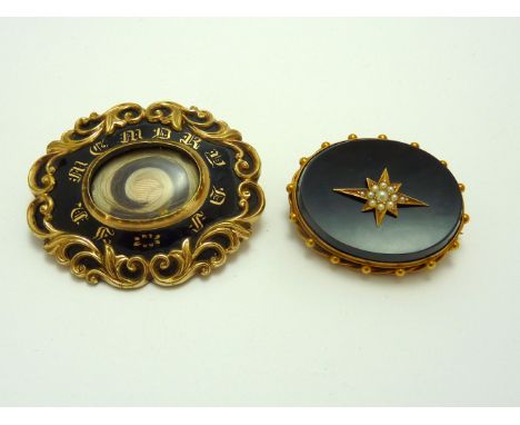 TWO VICTORIAN MOURNING BROOCHES, the first with a panel of hair to the front with black and gold enamel detail, the second wi