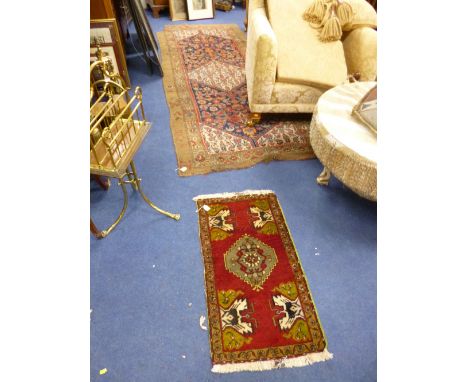 A BLUE AND RED GROUND RUG, with brown boarder, approximate size 300cm x 115cm, a small rug and a table runner (s.d.) (3)
