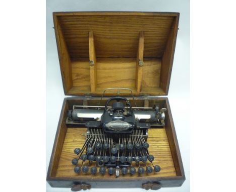 A BLICKENSDERFER NO.5 PORTABLE TYPEWRITER, labelled 'Newcastle-on-Tyne Made in USA', in black painted wood carry case