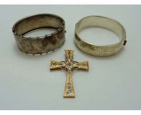 THREE ITEMS OF JEWELLERY, to include two decorative heavy silver hinged bangles, together with a rose gold black enamel ornat