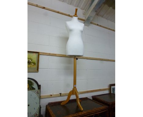 A FEMALE TORSO SHOP WINDOW MANNEQUIN, on polished wooden stand